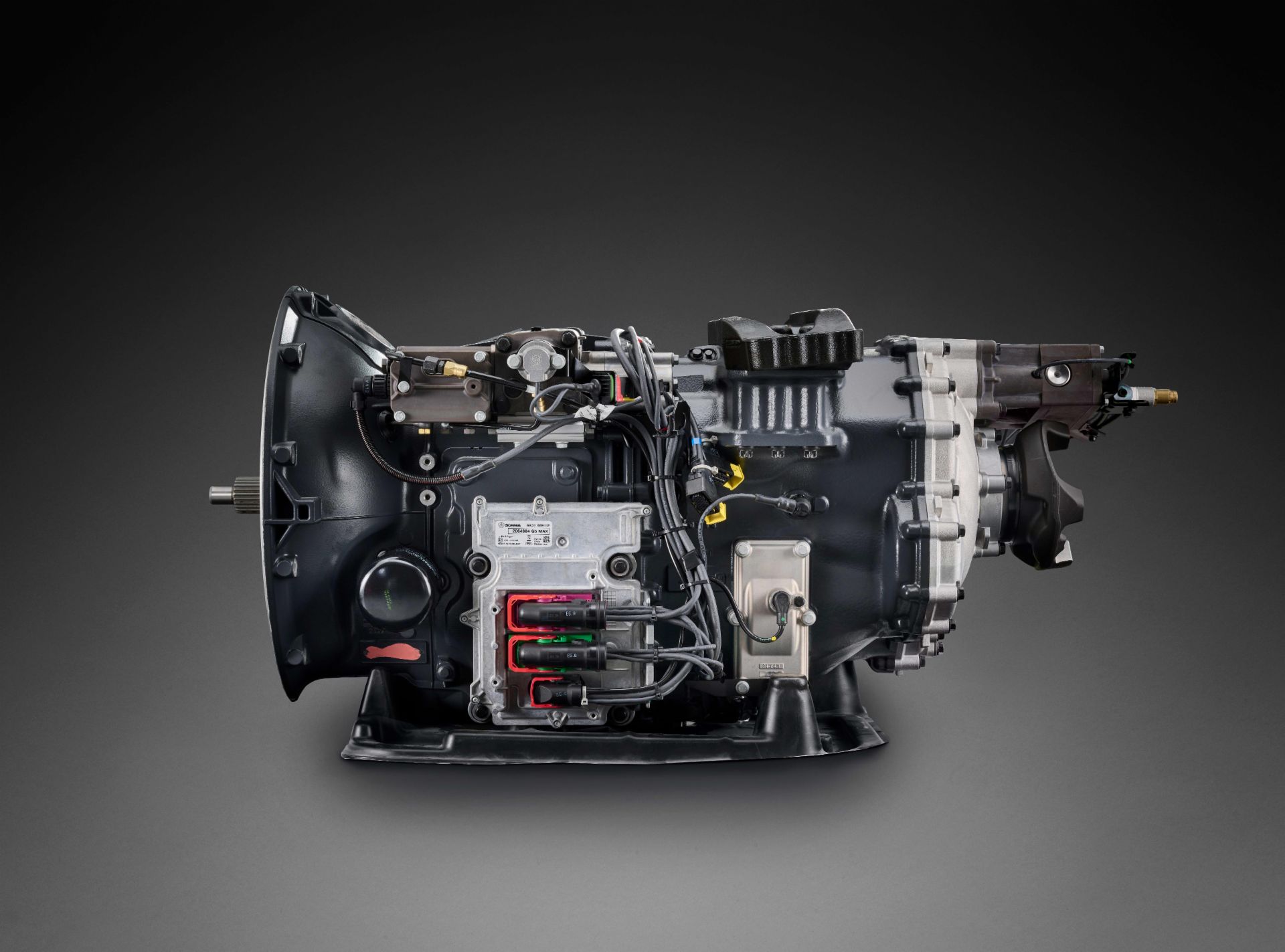 Close-up of a Scania heavy-duty transmission system with visible wiring and control components.