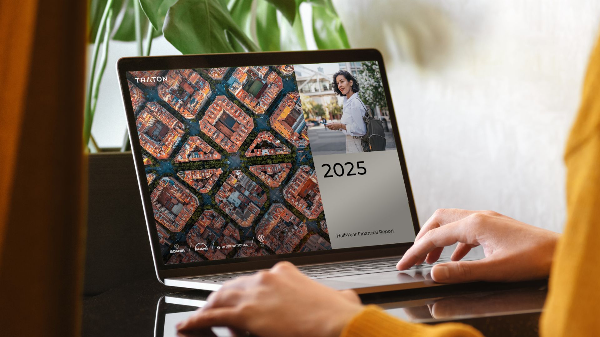 Laptop screen displaying a presentation featuring an aerial view of city blocks and a text box with the number 