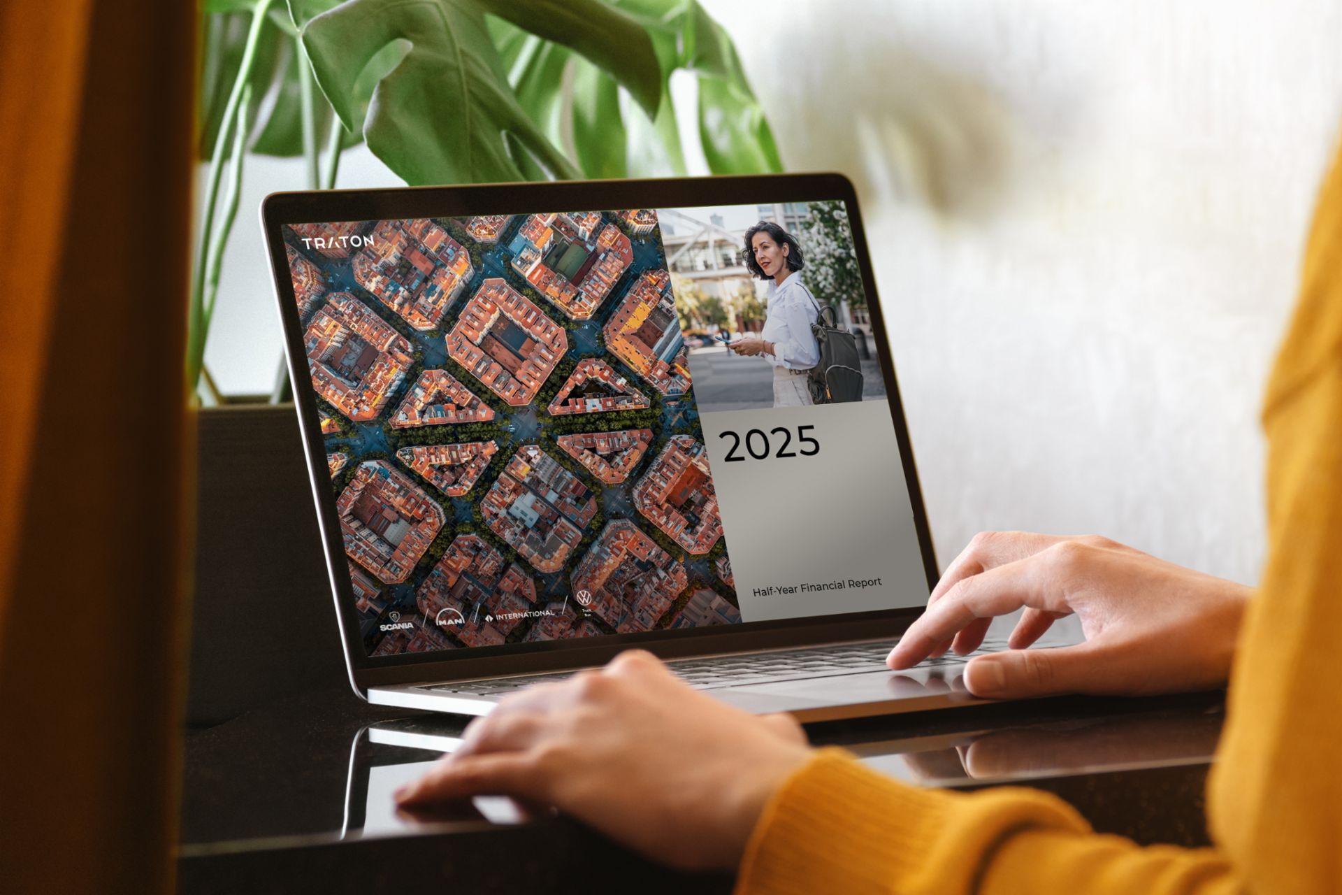 Laptop screen displaying a presentation featuring an aerial view of city blocks and a text box with the number 