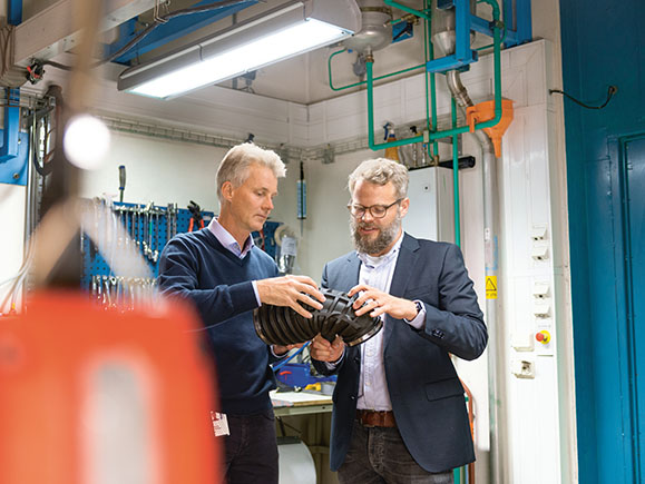 Magnus Henrikson und Florian Kraft beim prüfen eines Bauteils.